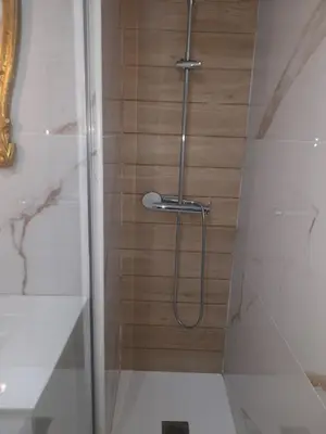 a shower with a hose in a bathroom at O Alecrim in Porto