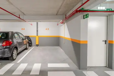 a parking garage with a car parked in it at Host Wise Stylish Studio with Garage in Porto