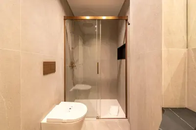 a bathroom with a shower with a toilet and a sink at DoisPontoZero Fonseca Cardoso in Porto