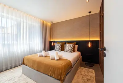 a bedroom with a large bed with a large window at DoisPontoZero Fonseca Cardoso in Porto