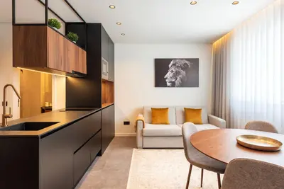 a kitchen and living room with a table and a couch at DoisPontoZero Fonseca Cardoso in Porto