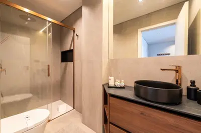 a bathroom with a black sink and a shower at DoisPontoZero Fonseca Cardoso in Porto