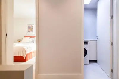 a bedroom with a door leading to a bed at Miguel Bombarda House in Porto