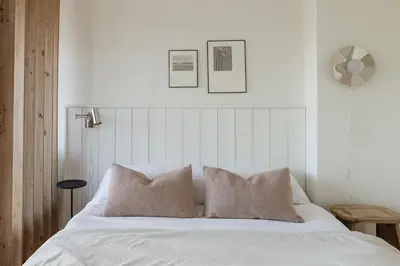 a bedroom with a white bed with two pillows at Oporto City View - Ferreira Cardoso in Porto