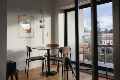 a dining room with a table and chairs and a balcony at Oporto City View - Ferreira Cardoso in Porto