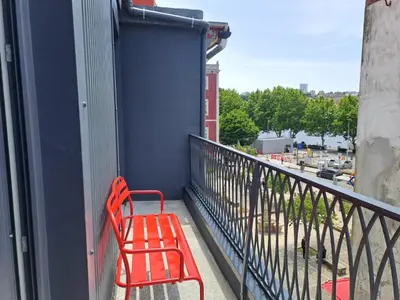 a red bench sitting on the side of a balcony at H2OPorto Miragaia - Riverfront apartments in Porto historic district in Porto