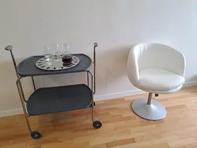 a table with wine glasses and a chair at H2OPorto Miragaia - Riverfront apartments in Porto historic district in Porto