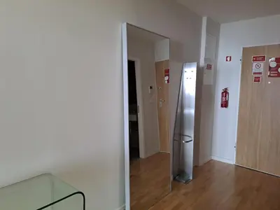 a room with a stainless steel refrigerator and a mirror at H2OPorto Miragaia - Riverfront apartments in Porto historic district in Porto