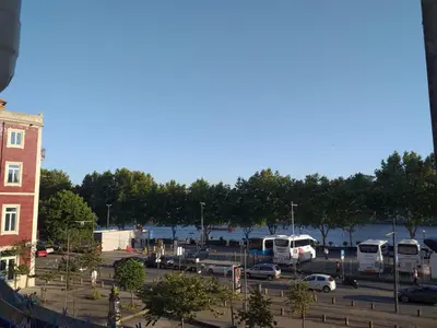 a parking lot with buses parked in a parking lot at H2OPorto Miragaia - Riverfront apartments in Porto historic district in Porto