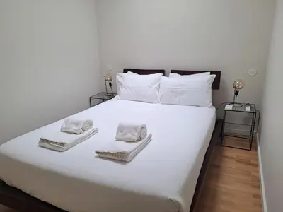 a bedroom with a white bed with towels on it at H2OPorto Miragaia - Riverfront apartments in Porto historic district in Porto
