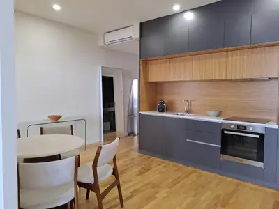 a kitchen with a table and some chairs and a counter at H2OPorto Miragaia - Riverfront apartments in Porto historic district in Porto