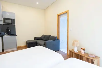 a living room with a bed and a couch at Studio at Campanha Station in Porto
