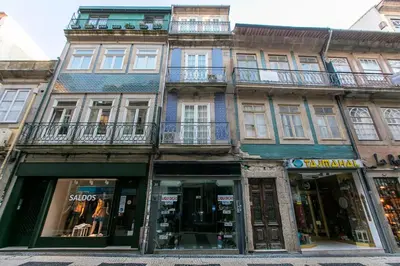 a building on a city street with a store at Cedofeita Back Garden in Porto