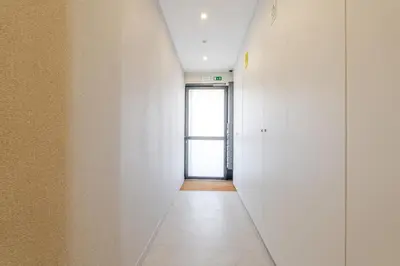 a hallway with white walls and a door at HostWise - Premium & Modern Building in Porto