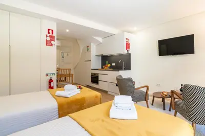 a hotel room with two beds and a kitchen at HostWise - Premium & Modern Building in Porto
