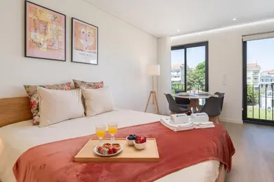 a bedroom with a bed with a tray of fruit on it at HostWise - Premium & Modern Building in Porto