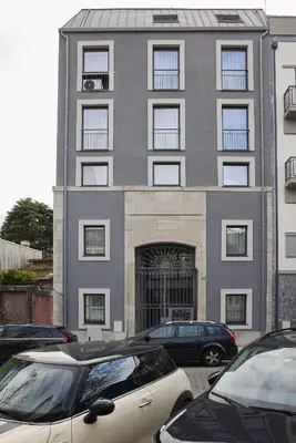 a building with cars parked in front of it at FLH Porto Central Apartments in Porto