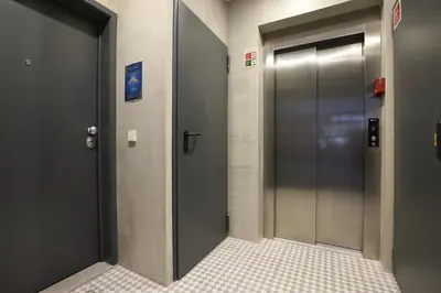 a corridor with two elevators in a building at FLH Porto Central Apartments in Porto