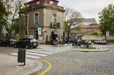 an old building on a city street with cars parked at FLH Porto Central Apartments in Porto