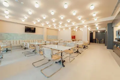 a classroom with tables and chairs and a chalkboard at ABC Hotel Porto - Campanhã in Porto