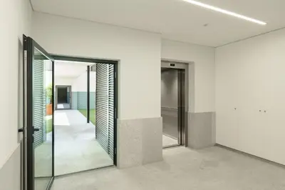 a pivot door in a room with mirrors at VIVA River Apartment Gaia in Vila Nova de Gaia