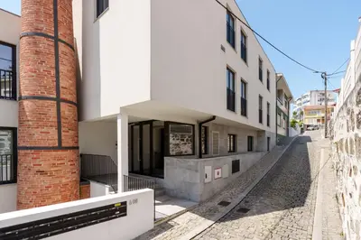 an empty street in front of a building at VIVA River Apartment Gaia in Vila Nova de Gaia