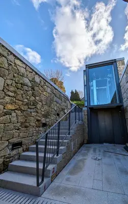 a stone wall with stairs and a glass door at Castelo River View - NEW in Vila Nova de Gaia