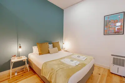 a small bedroom with a bed and a tv at Marques 1243 by Vacationy in Porto