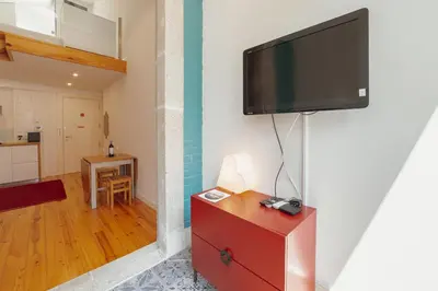 a living room with a flat screen tv on a wall at Marques 1243 by Vacationy in Porto