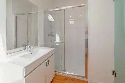 a bathroom with a white sink and a shower at Marques 1243 by Vacationy in Porto