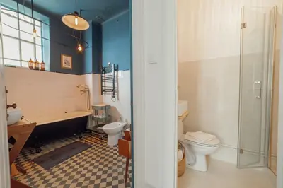 a bathroom with a tub and a toilet and a sink at Downtown Retro Bolhao by Vacationy in Porto