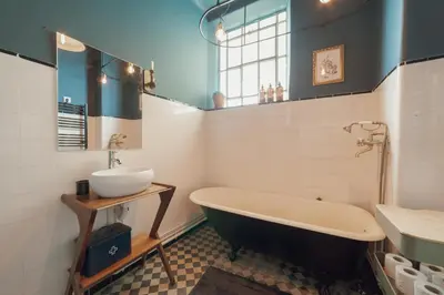 a bathroom with a bath tub and a sink at Downtown Retro Bolhao by Vacationy in Porto