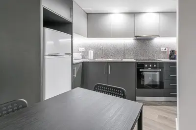 a kitchen with a wooden table and a table and chairs at GuestReady - Olivieri's House in Porto