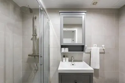 a white bathroom with a sink and a shower at GuestReady - Olivieri's House in Porto