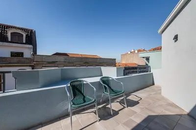 two chairs sitting on the balcony of a building at GuestReady - Olivieri's House in Porto