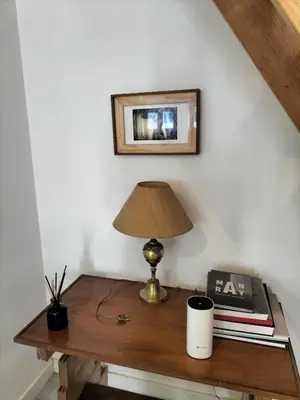 a table with a lamp and a picture on the wall at Casa Pedro Hispano 3B in Porto