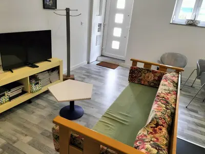 a living room with a couch and a flat screen tv at Casa Pedro Hispano 3B in Porto