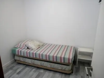 a small bed in a corner of a room at Casa Pedro Hispano 3B in Porto