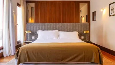 a bedroom with a large bed in a room at Being Porto Hostel in Porto