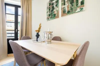 a dining room with a wooden table and chairs at Art Deco 31 Luxury 2BR Apartment Downtown Metro AC in Porto