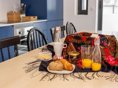 a table with a plate of bread and bottles of orange juice at Feel Porto Bacchus Townhouse in Porto
