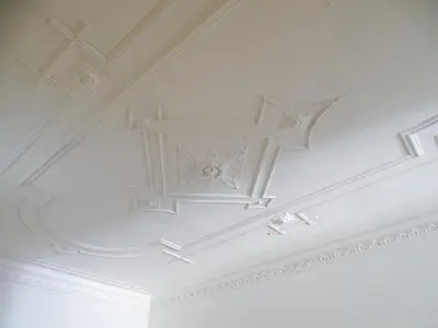 a white coffered ceiling with a design on it at O2 Hostel in Porto
