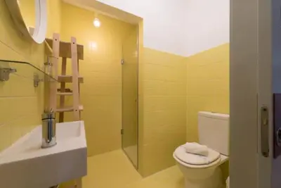 a bathroom with a toilet and a sink and a shower at Douro Central in Porto