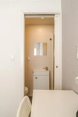 a small bathroom with a toilet and a sink at Petit Suites by PCALE in Porto