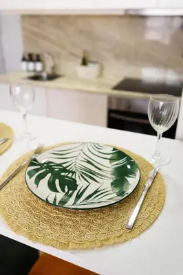 a plate on a table with two wine glasses at Green Universe Porto by MyMoradia in Porto