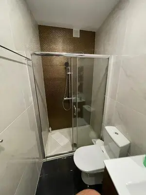 a bathroom with a shower and a toilet at Campanhã Clock House with terrace in Porto