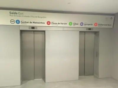 two elevators in a building with signs on the wall at The Glorious Apartment in Porto