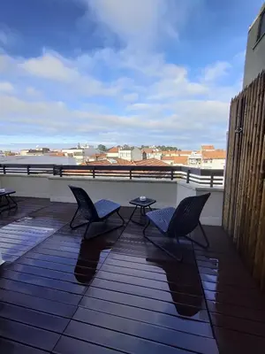 two chairs and a table on a balcony at Lindo Vale Guest House in Porto