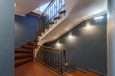 a winding staircase in a house with blue walls at Lindo Vale Guest House in Porto