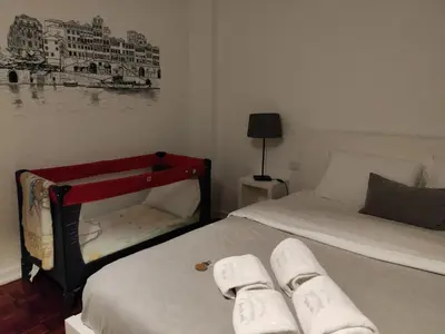 a bedroom with two beds and a painting on the wall at Lindo Vale Guest House in Porto